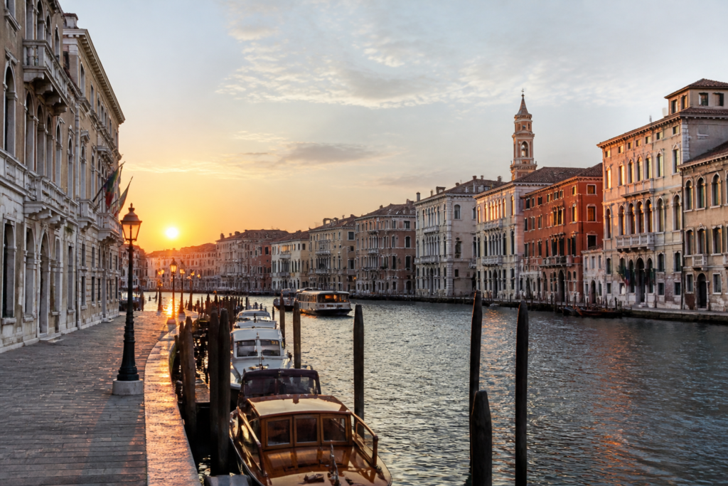 Quiet Venice canal at sunrise with historic buildings and a calm travel atmosphere