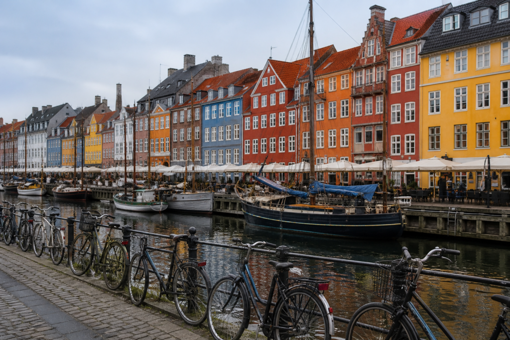 Colorful waterfront buildings and bicycles along a canal in Copenhagen, Denmark