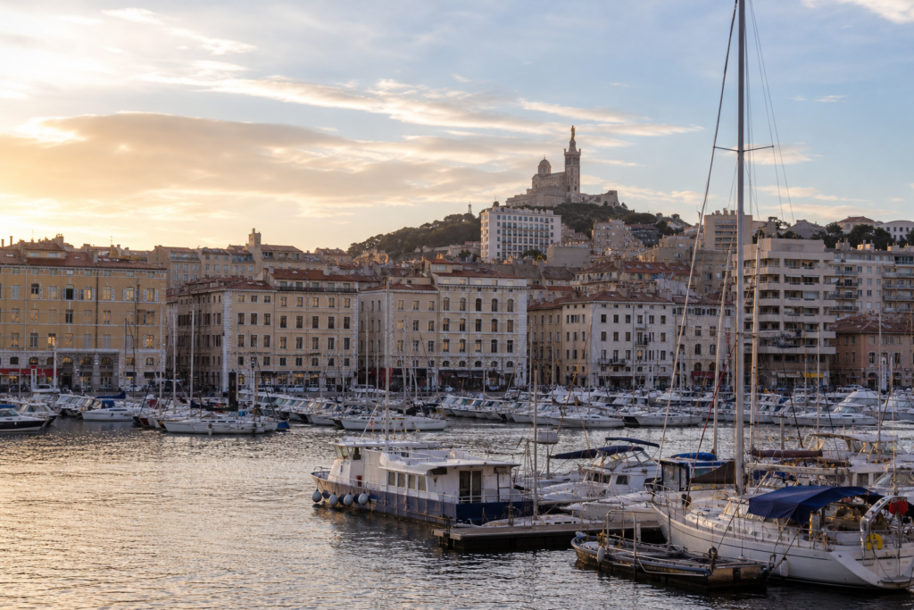 Marseille Old Port at golden hour with boats and the city skyline