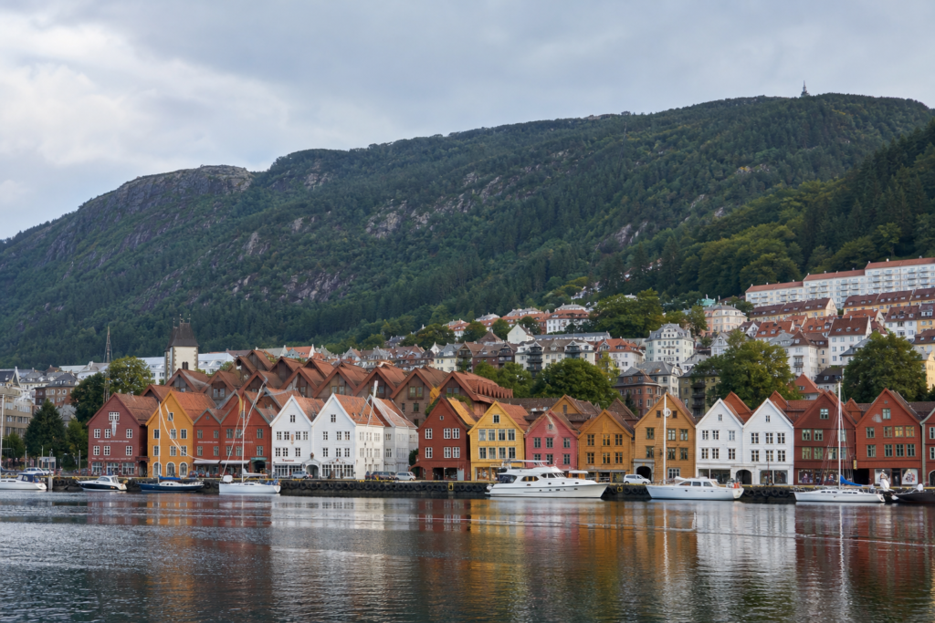 The colorful Bryggen waterfront in Bergen, Norway, with Mount Fløyen behind the city